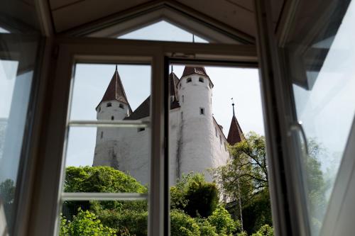 a view of a castle from a window at Ferienwohnung Schwert in Thun