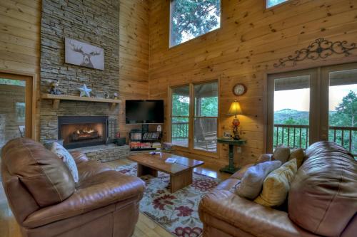 a living room with leather furniture and a fireplace at My Mountain Paradise in Morganton