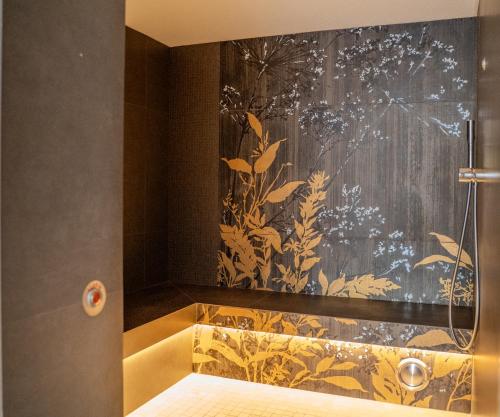 a bathroom with a shower and a yellow sink at Logis Hôtel Restaurant De La Poste et SPA de Montagne in Le Bonhomme