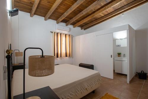 a bedroom with a bed and a table with a lamp at Casa dos Avós in Mértola