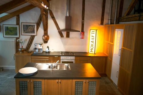 a kitchen with a sink and a stove at Ferienwohnung Schwert in Thun