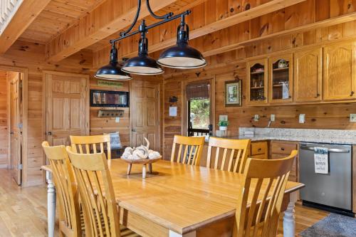 a kitchen and dining room with a wooden table and chairs at Oh Deer in Morganton
