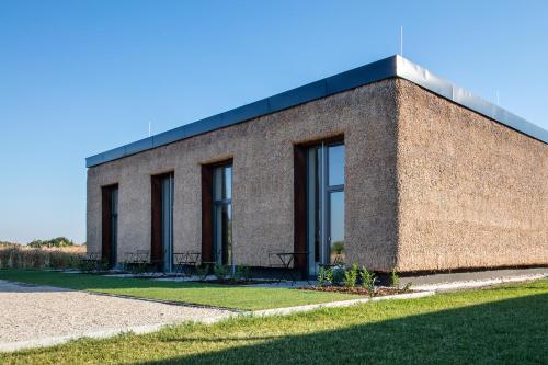 a brick building with windows on the side of it at Artkazal in Mórahalom