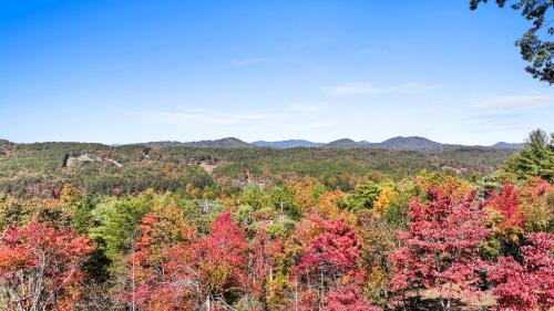 a view of a colorful forest with mountains in the background at Peaks & Pines in Morganton