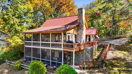 a home with a wrap around porch and a chimney at Peaks & Pines in Morganton