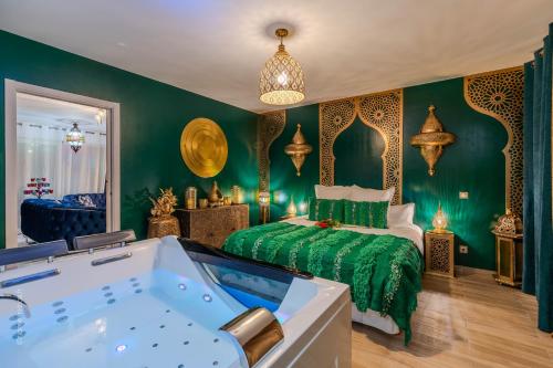 a bedroom with a bed and a bath tub at Suite Riad Luxe avec jacuzzi proche Disney in Nanteuil-lès-Meaux