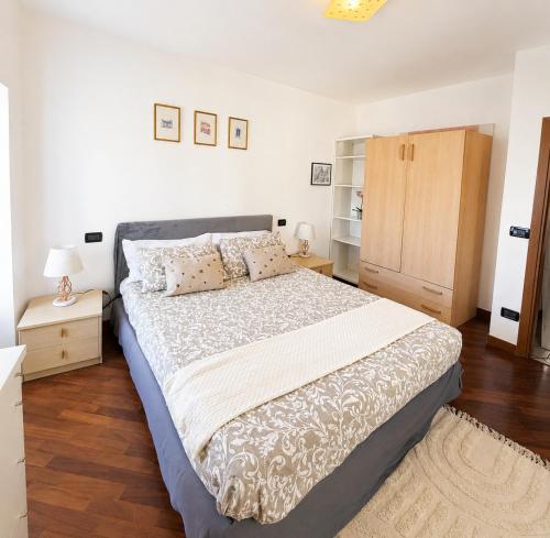 a bedroom with a large bed and wooden floors at Moniga Castle Apartment in Moniga
