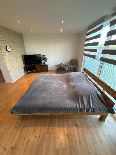 a bedroom with a large bed in a room at KC Appartments in Schwanau