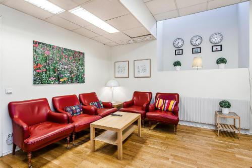 a living room filled with furniture and a red couch at City Hostel in Stockholm