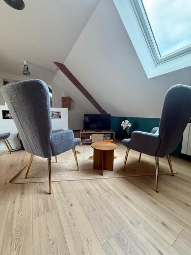 a living room with two chairs and a table at Comme en 40 in La Lande-sur-Drôme