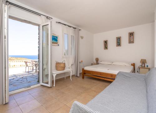 a bedroom with a bed and a view of the ocean at Popis Home in Faros