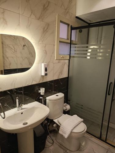 a bathroom with a toilet and a sink and a shower at Tamaya Hotel, Fifth Settlement, New Cairo in Cairo