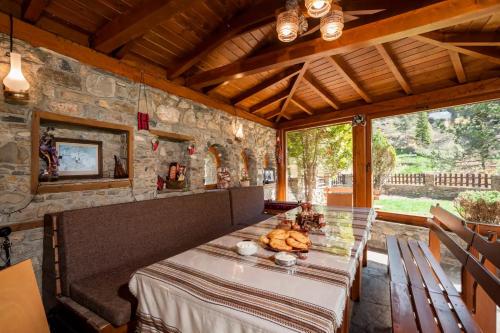 a dining room with a table with bread on it at Вила Соколето in Sokolovtsi