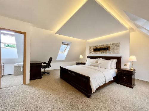 a bedroom with a bed and a desk and a piano at Mezonet Tatry in Vyšné Hágy