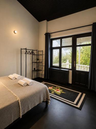 a bedroom with a bed and a large window at Kartepe Mountain Villa in Kartepe