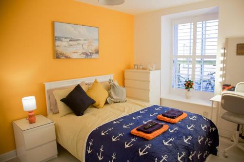a bedroom with a bed with two towels on it at The Wee Shore House in Ayr