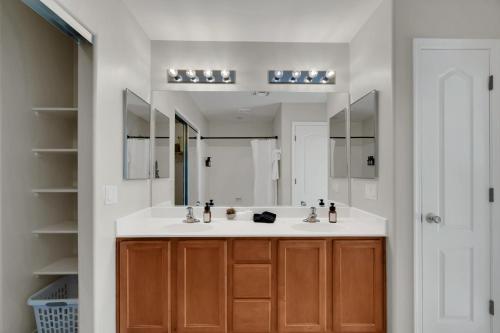 a bathroom with two sinks and a large mirror at Cactus Retreat Pool Fire Pit Pet Friendly in Green Valley