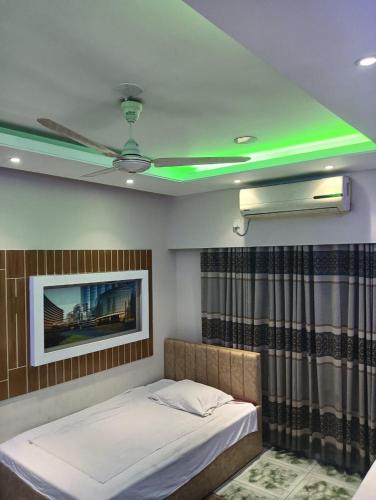 a room with a bed and a ceiling with green lights at Bliss Spa Gulshan - Spa in Gulshan in Bhola