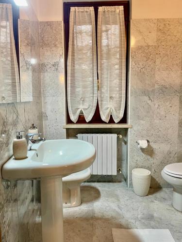 a bathroom with a sink and a toilet at Moniga Castle Apartment in Moniga