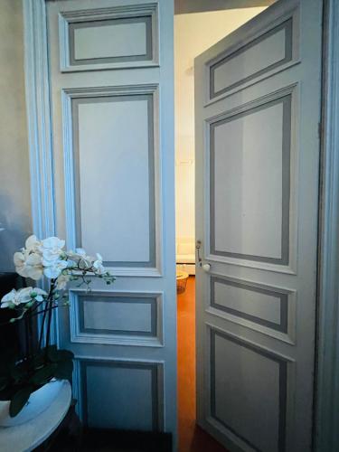 a door in a room with a vase of flowers at GITE chez "Chambre D'Hôtes Sandra" in Annot