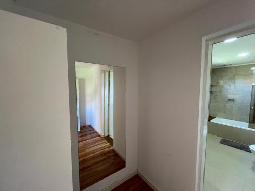 a bathroom with a tub and a sink and a mirror at Sierras de Canela premium in Tandil