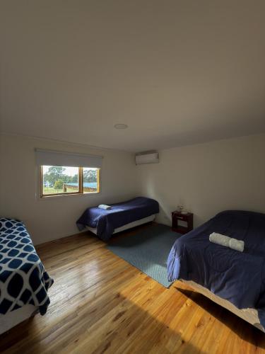 a bedroom with two beds and a window at Sierras de Canela premium in Tandil