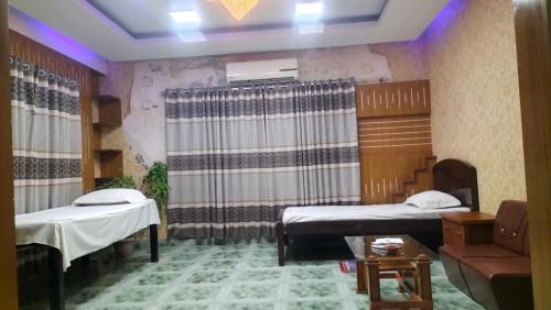 a hospital room with two beds and a couch at Bliss Spa Gulshan - Spa in Gulshan in Bhola