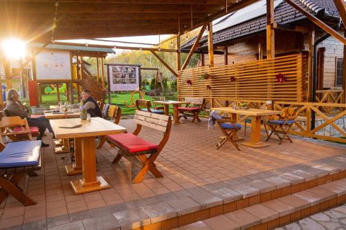 a patio with tables and chairs and a restaurant at Kedar selo Goč in Goč