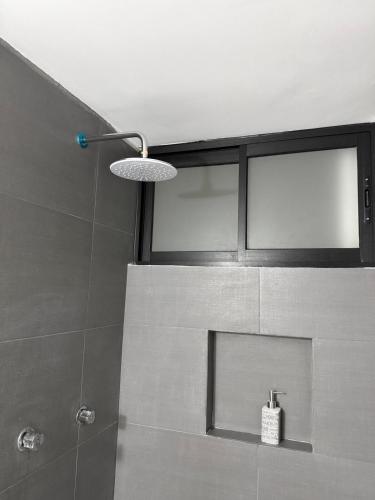 a bathroom with a shower with a glass wall at Nice downtown apartment Veracruz in Veracruz