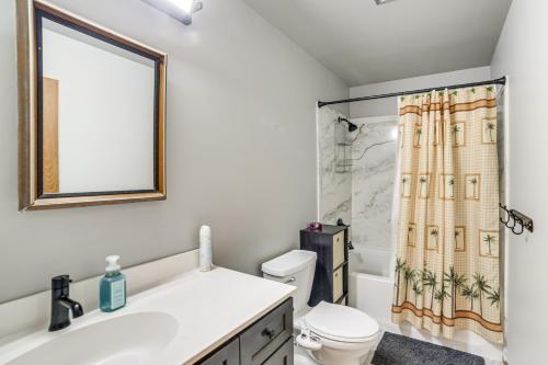 a bathroom with a sink and a toilet and a shower curtain at Explore the Upper Peninsula! Marquette Home in Marquette
