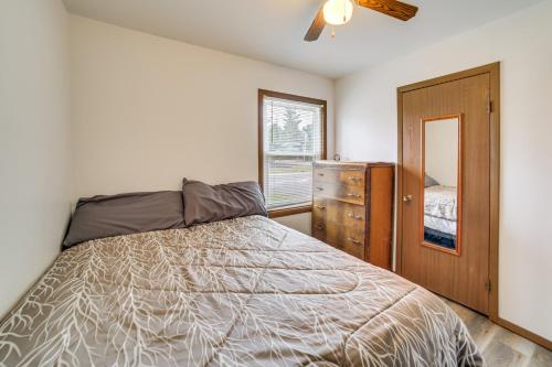 a bedroom with a bed and a dresser and a window at Explore the Upper Peninsula! Marquette Home in Marquette
