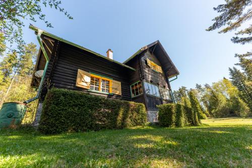 a wooden house on a green lawn at Špengel chata in Smižany