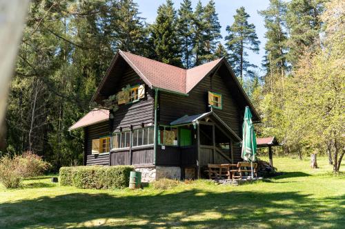 a large wooden house in the middle of a yard at Špengel chata in Smižany