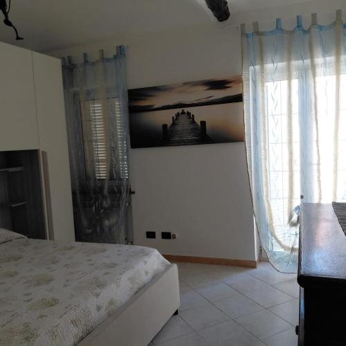 a bedroom with a bed and a window at L'albero del druido in Villastellone