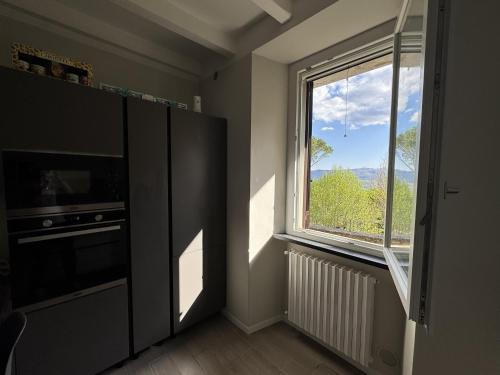 a room with a large window and a television at alloggioaltorrione in Citerna