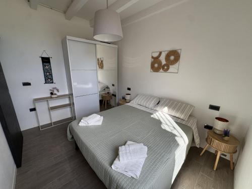 a bedroom with a bed with two towels on it at alloggioaltorrione in Citerna