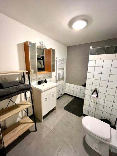 a bathroom with a toilet and a sink at Studio Cosy et Moderne in Saint-Ambroix