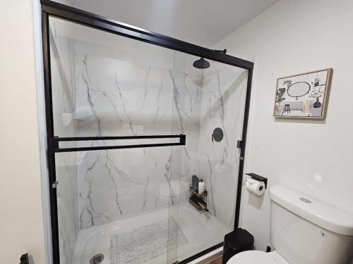 a bathroom with a marble shower and a toilet at Stargaze Grand Canyon in Meadview
