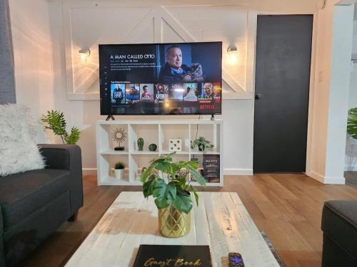 a living room with a couch and a tv at Stargaze Grand Canyon in Meadview