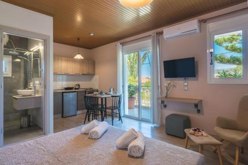 a room with a bed and a kitchen and a room with at Siora Maria in Argostoli