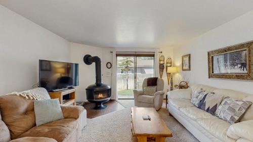 a living room with a couch and a stove at Lake Town Access Deck Pool Wood Stove in McCall
