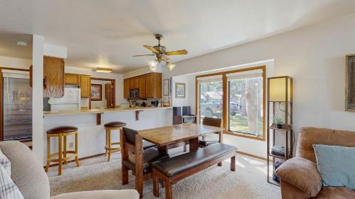 a living room with a table and a kitchen at Lake Town Access Deck Pool Wood Stove in McCall