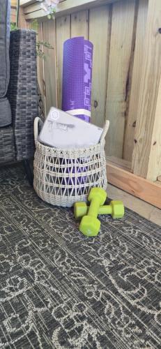 a chair sitting on the floor next to a basket at Villa Serena Tuscan Theme home with a HIDDEN lounge, fire pit, lawn games, creek in Dahlonega