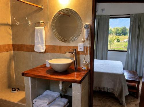 a bathroom with a sink and a mirror at Entre Montañas in Tafí del Valle