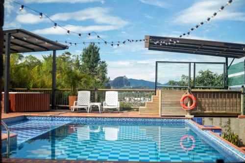 a swimming pool with a view of the mountains at Hotel Estaciones in Guatapé