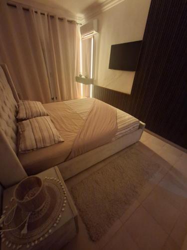 a bedroom with a bed and a table with a hat on it at Appartement MARINA AP4 SAIDIA in Saïdia