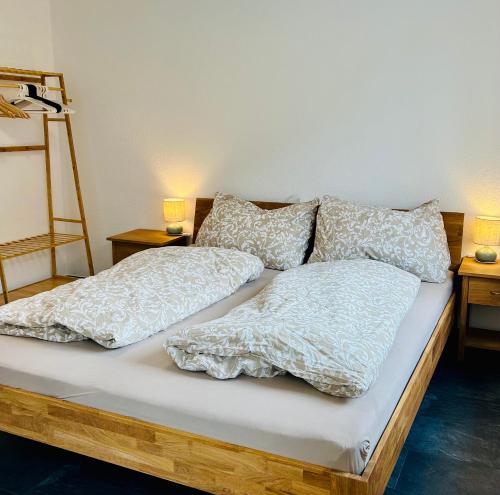 a bed with two pillows on top of it at Ferienwohnung Alpenpfad in Elmen