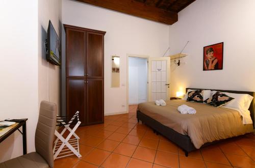 a bedroom with a bed and a table and a desk at Dimora Cavour 1810 in Civitavecchia