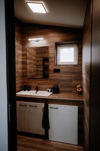 a bathroom with a sink and a mirror at Time to Relax in Zalakaros