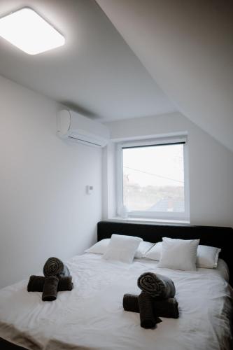 a bedroom with a large bed with towels on it at Time to Relax in Zalakaros